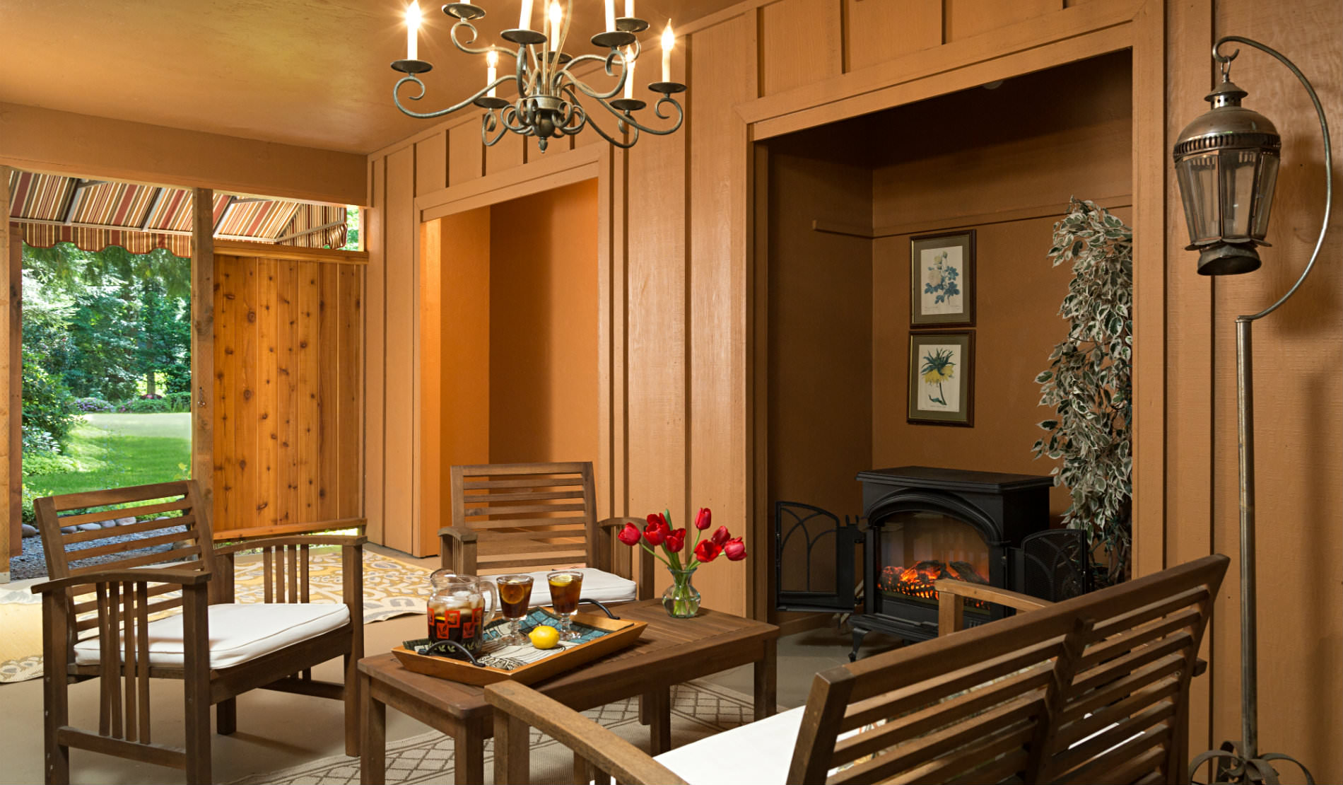 Wood Paneled room with wooden chairs and table set with cold drinks.